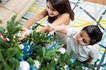 Children decorating Christmas tree