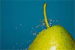 Close up of water splashing on pear