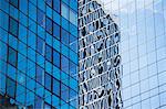 Urban skyscraper reflected in windows