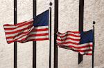 American flags flying by skyscraper