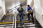 Couple climbing subway steps