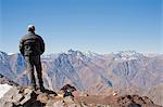 Hiker overlooking snowy mountains