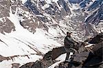 Hiker walking on rocky mountainside