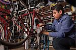 Mechanic working in bicycle shop