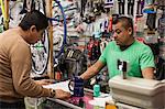 Mechanic and customer in bicycle shop