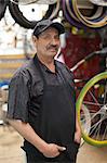 Mechanic standing in bicycle shop