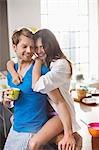 Smiling couple hugging in kitchen