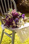 Bouquet of flowers in chair outdoors