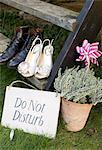 Newlywed couple's shoes with 'do not disturb' sign