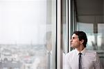 Businessman looking out office window