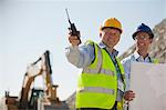 Businessmen talking in quarry