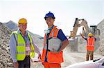 Worker and businessman standing in quarry