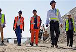 Workers and business people walking in quarry