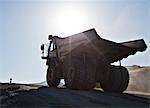 Silhouette of truck in quarry