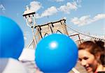 Couple with balloon walking on urban bridge