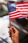 Woman with novelty nails waving American flag