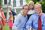 Three generations of men smiling together