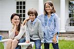 Mother and children smiling outdoors