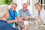 Friends playing card games at table