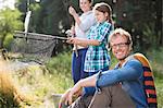 Family fishing together in tall grass