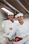 Chefs smiling in restaurant kitchen