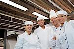 Chefs smiling in restaurant kitchen