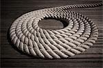 Rope coiled in circle on boardwalk