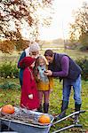 Family using cell phone together outdoors