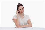 Cute businesswoman making a phone call against a white background