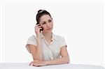 Young businesswoman making a phone call against a white background