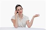 Businesswoman speaking on the phone against a white background