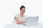 Businesswoman using a notebook against a white background