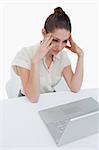 Portrait of a thoughtful businesswoman using a notebook against a white background