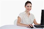 Cute businesswoman using a monitor against a white background