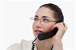 Close up of a secretary making a phone call against a white background