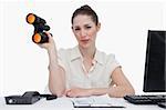 Businesswoman holding binoculars against a white background