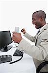 Portrait of a cheerful businessman using a computer against a white background