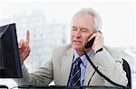 Focused senior manager on the phone in his office