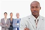 Tradesman with team behind him against a white background