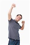 Successful young man celebrating against a white background