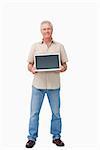 Smiling mature male presenting his laptop screen against a white background