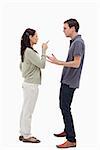 Woman scolding man against white background