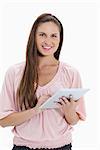 Close-up of a smiling girl using a touchpad against white background