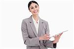 Smiling young saleswoman with her tablet computer against a white background