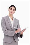 Businesswoman ready to take notes against a white background