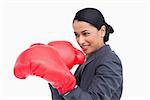 Close up side view of saleswoman with boxing gloves against a white background