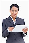 Close up of saleswoman using touch screen computer against a white background