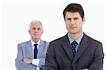 Close up of serious businessman with his mentor behind him against a white background