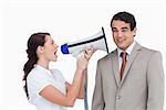 Saleswoman with megaphone yelling at colleague against a white background