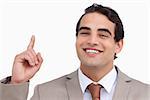 Close up of smiling salesman pointing up against a white background